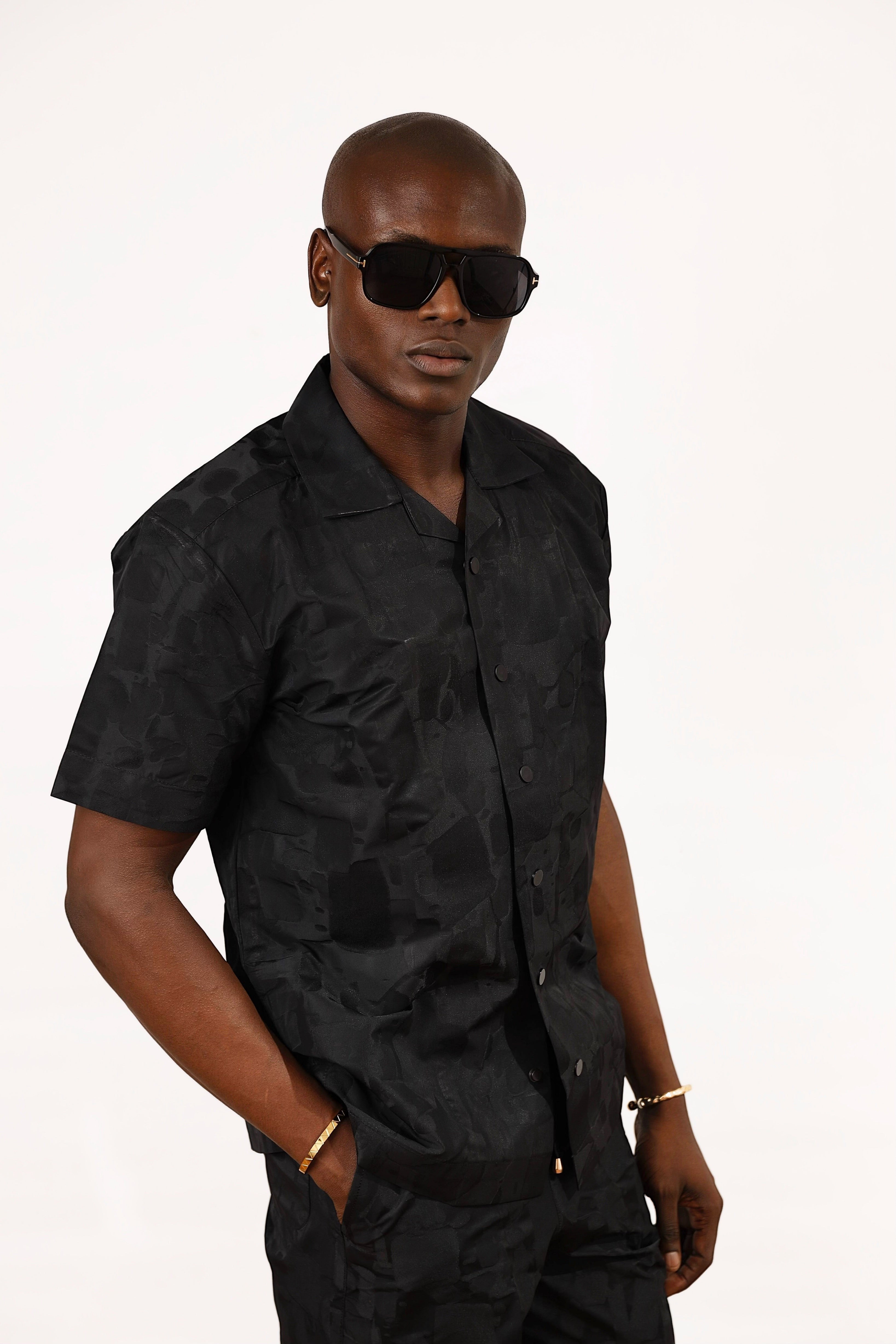 Shop Frugal black brocade short-sleeve Cuban shirt with a textured weave and relaxed fit. Model wears size L.